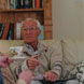 Old man takes a tea cup - photo